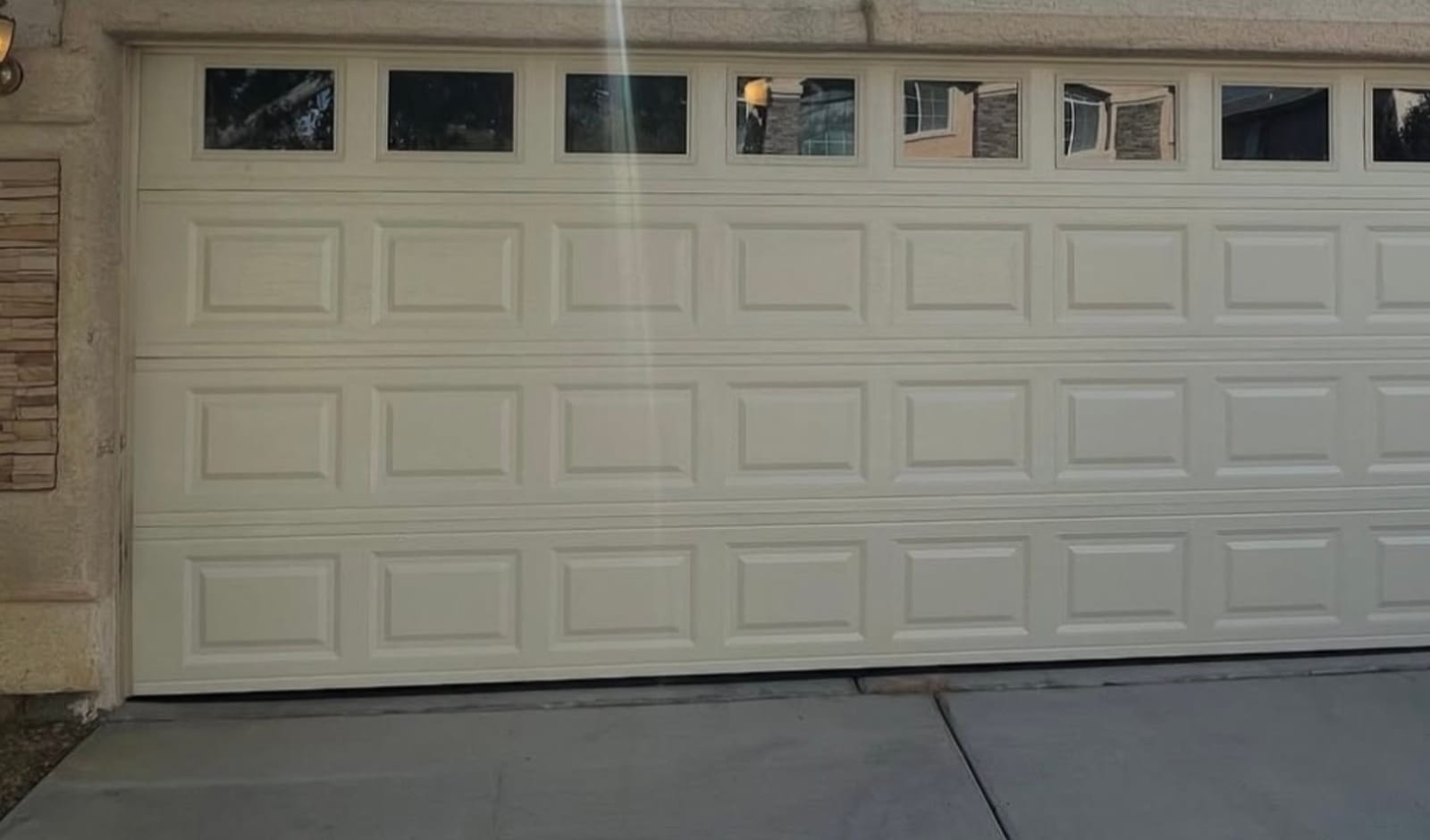 Raised-panel garage door with window inserts