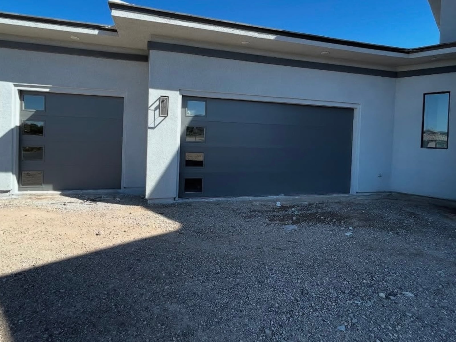 Modern flush-panel garage doors on a new build