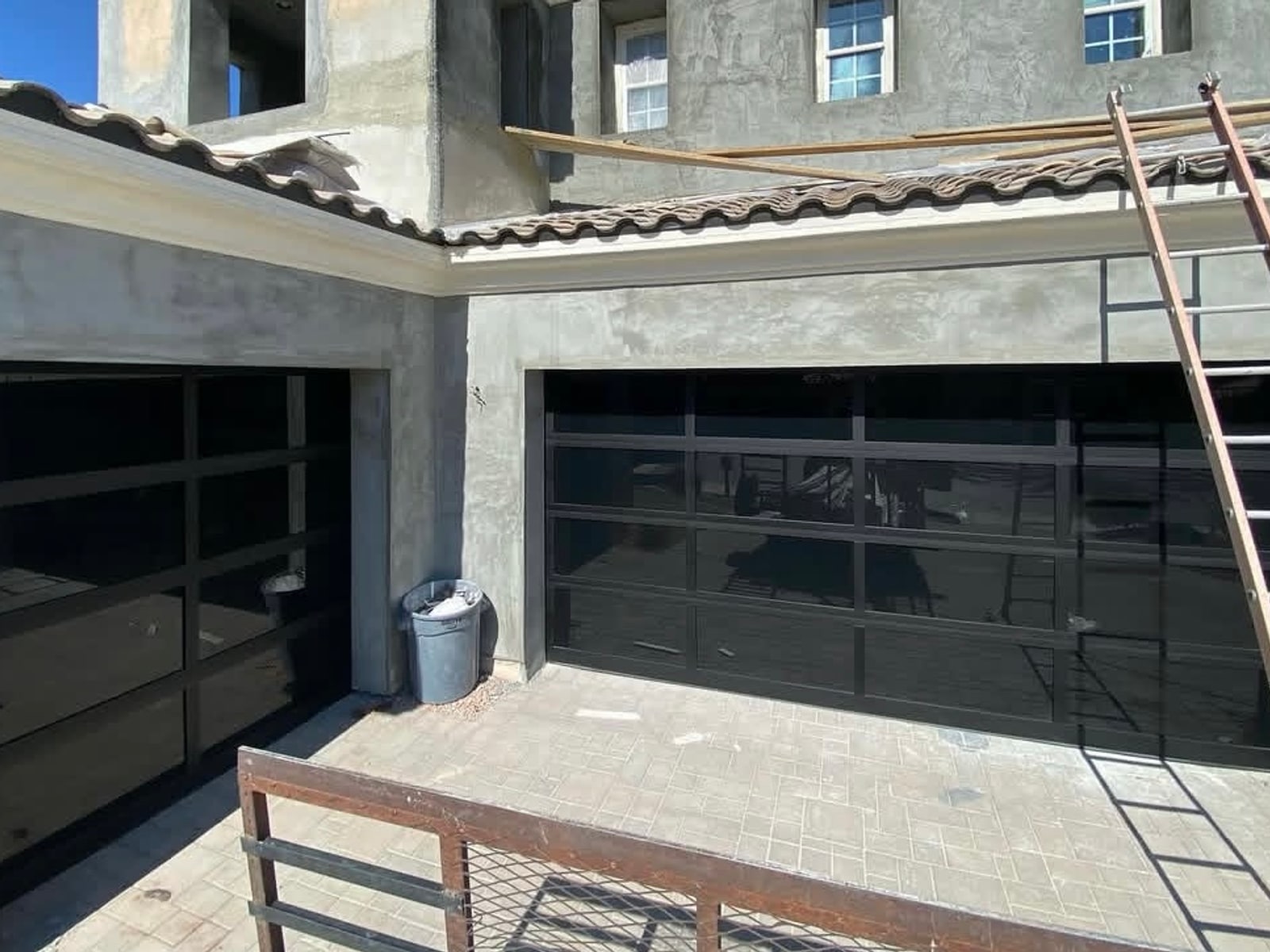 Black glass garage doors installed on a custom home